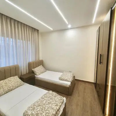a hotel room with two beds and a window at Cozy 3BR Apartment by 7th Circle in Amman