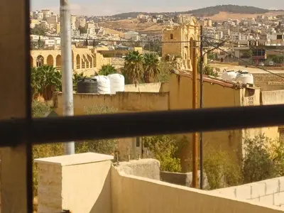 a view of a city from a balcony at Jeeso Hotel in Jerash
