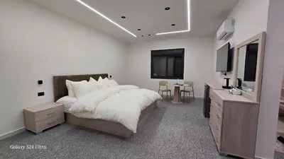 a bedroom with a bed and a television in it at Jeeso Hotel in Jerash