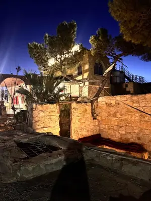 an old stone building with a tree and a building at TOWER Hotel in Dana