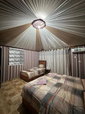 a bedroom with two beds in a tent at Eileen wadi rum camp in Wadi Rum