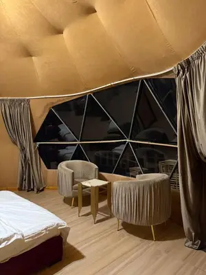 a room with two beds and two chairs at Eileen wadi rum camp in Wadi Rum