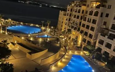an overhead view of two swimming pools at night at Family WeekEnds Getaways at Samarah Resort Studio in Sowayma