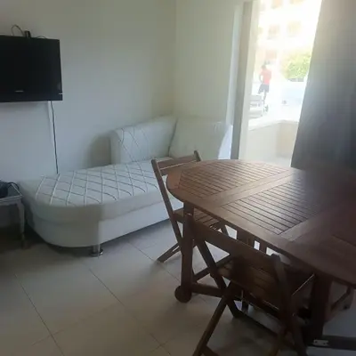 a living room with a couch and a table at Family WeekEnds Getaways at Samarah Resort Studio in Sowayma