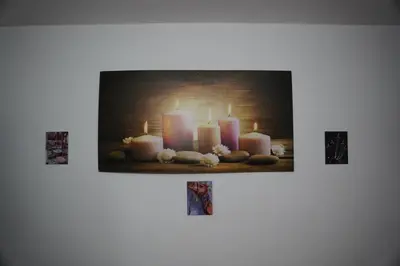 a group of burning candles on a wall at Petra Visitor Center Apartment in Petra