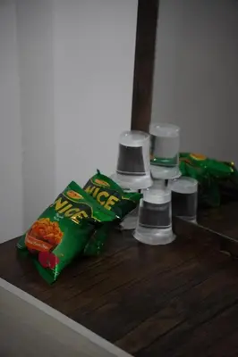 a pile of snacks on a wooden table in front of a mirror at Petra Visitor Center Apartment in Petra