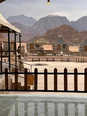 a fence with a view of a desert with mountains at Sana Rum Luxury Camp in Wadi Rum