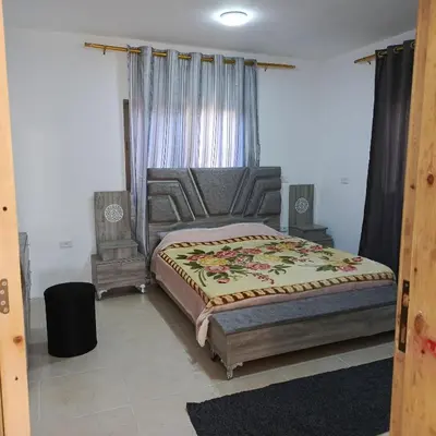 a bedroom with a bed and a window at ابو عبدالله للشقق الفندقيه in Ajloun