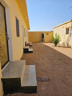 a door of a building with a bench next to it at Rum Adventures Hostel in Wadi Rum
