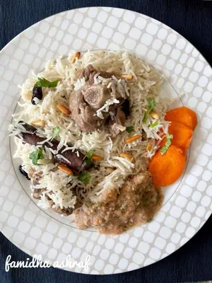 a plate of food with rice and meat and carrots at Rum Adventures Hostel in Wadi Rum