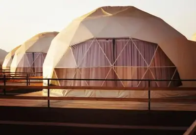 a row of domed tents on a deck at وادي رم in Wadi Rum