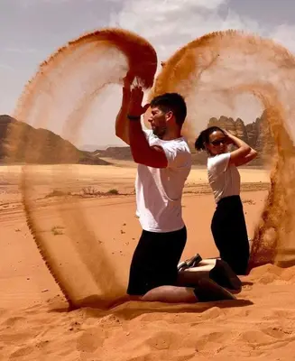 a man and a woman standing in the desert at LAVRA lUXURY CAMP in Wadi Rum