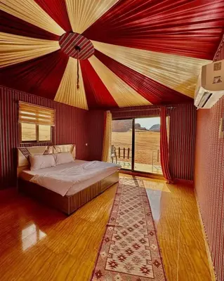 a bedroom with a bed with a red ceiling at LAVRA lUXURY CAMP in Wadi Rum
