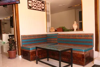 a bench in a store with a table at PetraEcho lodge Section B Home in Wadi Musa