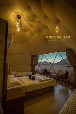 a hotel room with a bed and a view of the desert at Horizon Star Golden Camp in Wadi Rum