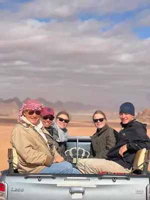 a group of people sitting in the back of a truck at Horizon Star Golden Camp in Wadi Rum