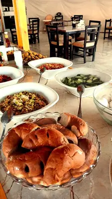 a table topped with plates of bread and other food at SILENT SKY lUXURY CAMP in Wadi Rum