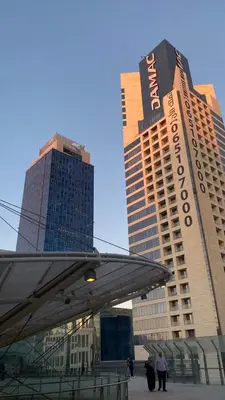 a group of buildings with people standing in front of it at Studio at Damac Jordan in Amman