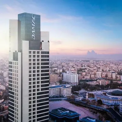a tall building with a sign on top of it at Studio at Damac Jordan in Amman