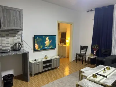 a living room with a flat screen tv on a wall at A double bed apartment in heart of Amman شارع سلطان الهند خلف ش عبدالله غوشه in Amman