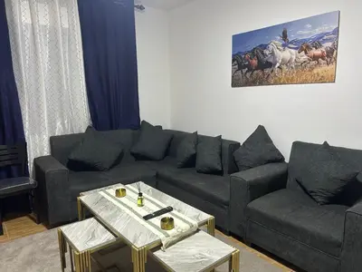 a living room with a couch and a table at A double bed apartment in heart of Amman شارع سلطان الهند خلف ش عبدالله غوشه in Amman