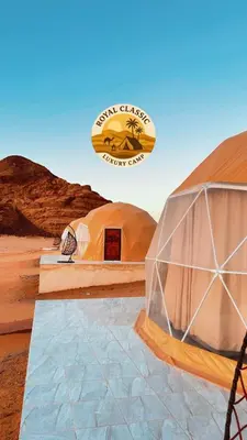 two domes in the desert with a sign in the background at RUM ROYAL CLASSIC lUXURY CAMP in Disah