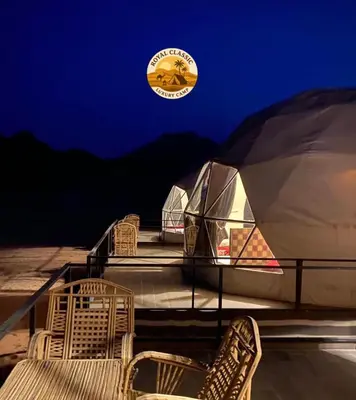 a group of chairs sitting on top of a tent at RUM ROYAL CLASSIC lUXURY CAMP in Disah
