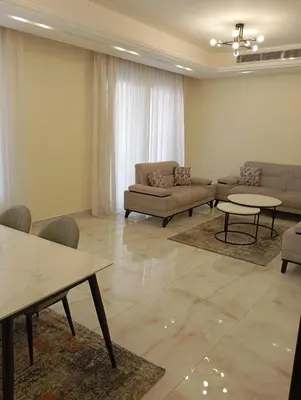 a living room with couches and tables in a room at شقه مفروشه in Amman
