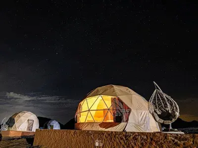 a group of domes under a starry sky at moon and sky camp in Wadi Rum