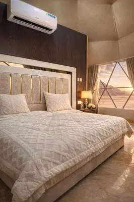 a bedroom with a large bed with a ceiling at moon and sky camp in Wadi Rum