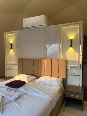 a bedroom with a large bed with two mirrors at Al-Najm Coastal Camp Rum in Wadi Rum