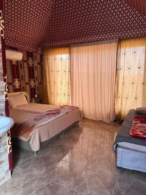 a bedroom with two beds in a room with curtains at Ayloulcamp in Disah