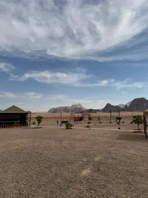 a park with benches in the middle of the desert at Ayloulcamp in Disah