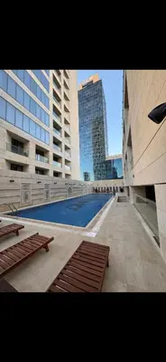 a view of a swimming pool in a building at DAMAC Tower Amman boulevard برج داماك - عمان البوليفارد العبدلي in Amman