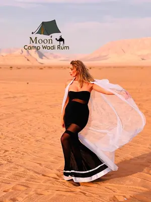 a woman in a dress walking in the desert at Moon Camp Wadi Rum in Wadi Rum