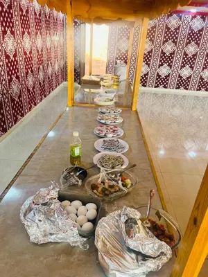 a table with many plates of food on it at Moon Camp Wadi Rum in Wadi Rum