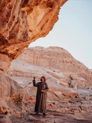 a man standing in front of a rock formation at Wadi Rum Bedouin Life in Wadi Rum