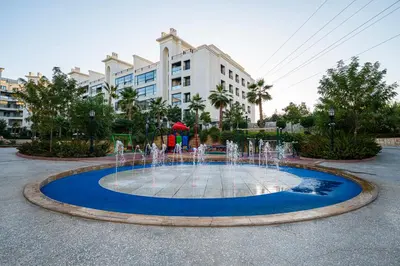 a fountain in a courtyard in front of a building at كمباوند المطار شقه مفروشة in Amman