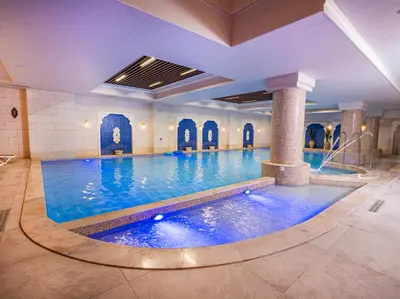 a large swimming pool in a hotel room at كمباوند المطار شقه مفروشة in Amman