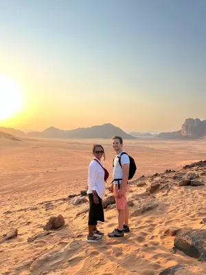 two people standing in the desert at sunset at Wadi Rum Star Haven camp in Wadi Rum