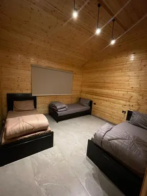 a room with two beds and a projection screen at Cherry farm in Ajloun