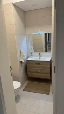 a bathroom with a sink and a toilet and a mirror at Luxury apartments in Ayla in Aqaba