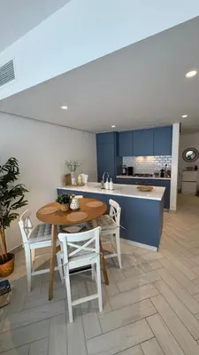 a kitchen and dining room with a table and chairs at Luxury apartments in Ayla in Aqaba