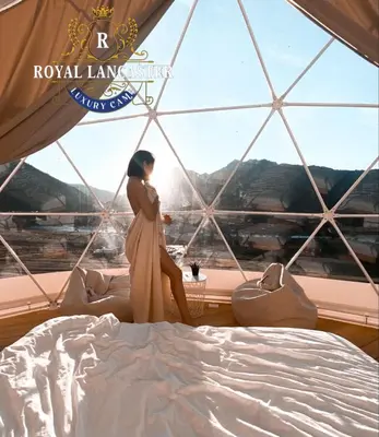 a woman in a dress standing in front of a window at ROYAL LANCASTER lUXURY CAMP in Wadi Rum