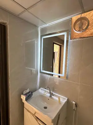 a bathroom with a sink and a mirror at ROYAL LANCASTER lUXURY CAMP in Wadi Rum