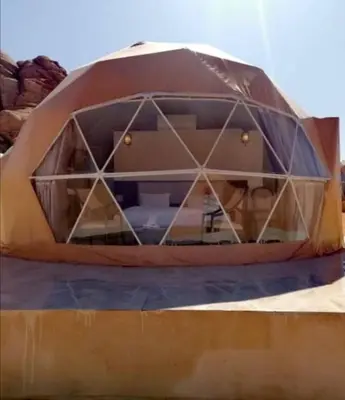 a tent that is sitting on top of a bed at mountains wadi rum in Disah