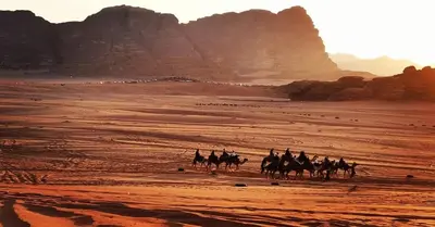 a group of people riding horses in the desert at mountains wadi rum in Disah