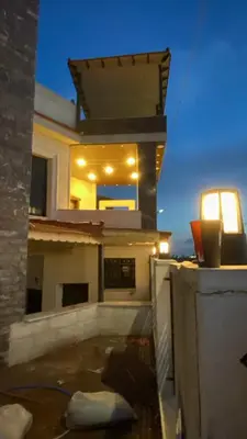 a view of a house from a balcony at night at فيلا سالم عبدالرحمن الأشــــــقــــر ابو حمزه Villa Salem Alashqar in Maḩaţţat al Jīzah