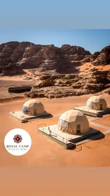 three tents in a desert with rocks in the background at Thirteen Luxury Camp Valley in Wadi Rum
