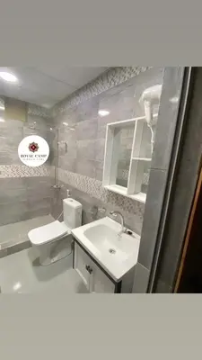 a bathroom with a sink and a toilet and a mirror at Thirteen Luxury Camp Valley in Wadi Rum